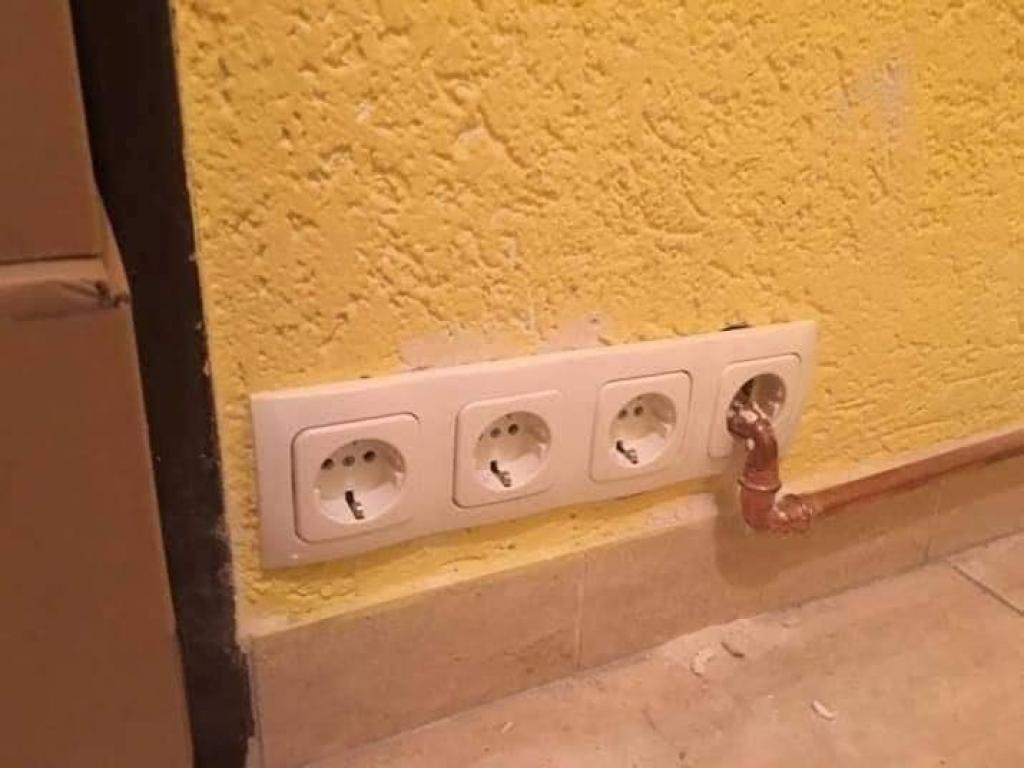 A water pipe that passes through an electrical outlet
